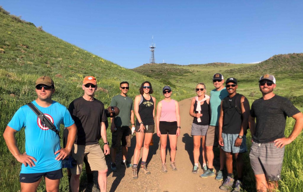 Salute Colorado team smiling and posing on a hiking trail.
